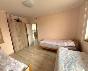 a room with two beds and a cabinet in it at Pista house in Beograd