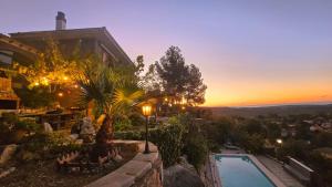 a house with a swimming pool and a sunset at Vida Daurada, sunny oasis with private pool in Vespellá +21 photos