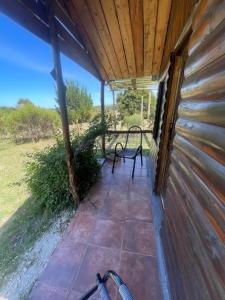 a porch of a house with a bench on it at Las calandrias in Barrio Copacabana