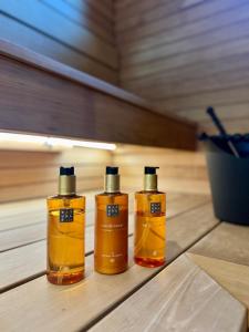 three bottles sitting on top of a wooden table at Levi City Suite - Central & Stylish with Free Ski Passes in Levi +19 photos