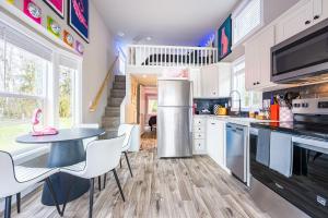 a kitchen with a table and a table and chairs at Rainforest Tiny Home Retreat #17 Abstract Modern in Forks +34 photos