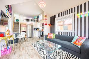 a living room with a blue couch and a kitchen at Rainforest Tiny Home Retreat #17 Abstract Modern in Forks