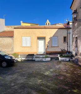 a car parked in a parking lot in front of a house at Antoni House in Bulzi