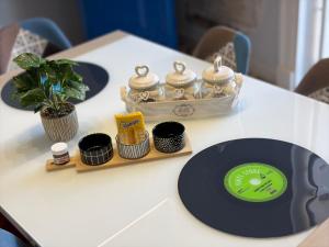 a table with a green frisbee and a clock on it at Elisir house in Palermo