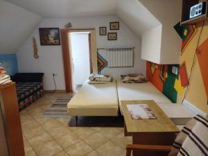 a small room with a bed and a couch at Perníčka in Leštiny
