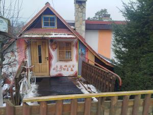 a small house with a snow covered front porch at Perníčka in Leštiny