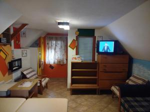 a living room with a tv on a dresser at Perníčka in Leštiny