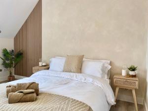 a bedroom with a large bed with white sheets and pillows at Luxury Scandi Inspired 1 Bed Apartment in Bournemouth +16 photos