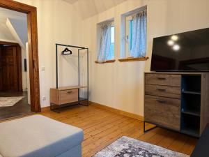 a living room with a tv and a dresser at Business Apartment in Paderborn