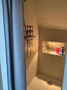 a shower with a shower curtain in a bathroom at Business Apartment in Paderborn