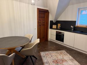 a kitchen with a table and chairs in a room at Business Apartment in Paderborn