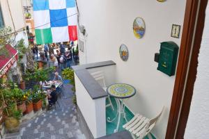 a balcony with a table and a crowd of people at Casa Bianca Amalfi New Central Apt in Amalfi