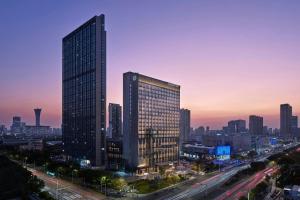 a city skyline at dusk with a tall building at Sheraton Ningbo Yinzhou in Ningbo