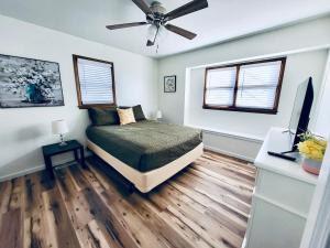 a bedroom with a bed and a ceiling fan at The Willowdell Nook in Mulvane