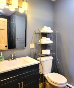a bathroom with a sink and a toilet and a mirror at Cold Brook Lodge - 2 and 3 Bedroom Luxury Apartments in Lake Placid +129 photos