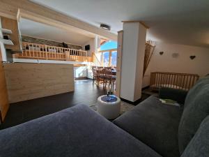 a living room with a couch and a table at Leitingerhof in Virgen