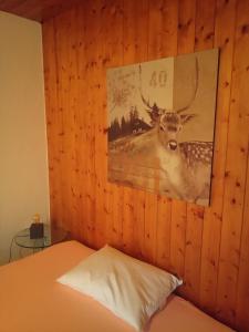 a bedroom with a picture of a deer on the wall at Gästezimmer Stadtpark in Biel +9 photos