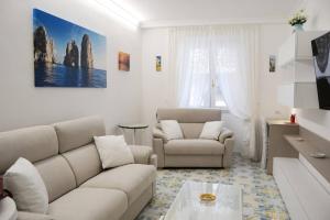 a living room with a couch and a table at Casa Bianca Amalfi New Central Apt in Amalfi