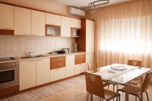 a kitchen with a table and a dining room at Hana's Apartment in Durrës