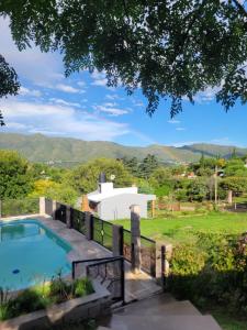a house with a swimming pool and mountains in the background at Balcones de Bialet in Bialet Massé