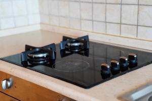 a stove top in a kitchen with a counter at Hana's Apartment in Durrës +18 photos