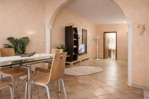 a kitchen with a table and chairs in a room at Hana's Apartment in Durrës