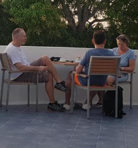 two men and a woman sitting at a table at Clove Beach in Addu Atoll +32 photos