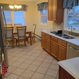 a kitchen with a sink and a table with chairs at Cliffside Cottage in Mansfield