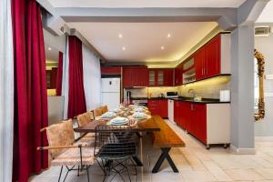 a kitchen with red cabinets and a table and chairs at Bright Apart Hotel in Istanbul