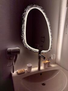 a bathroom sink with a round mirror on the wall at Casa Luna Beach-Front Suite in Dahab +13 photos