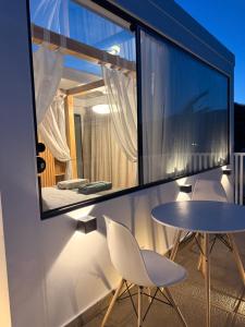 a room with a table and chairs on a balcony at Casa Luna Beach-Front Suite in Dahab