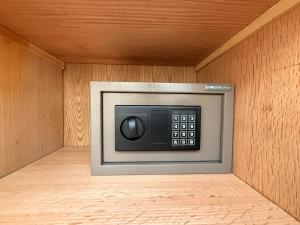 a microwave oven in a room with a wooden wall at Casa Luna Beach-Front Suite in Dahab