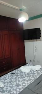a room with a white and black floor and a light at La Pradera in Pereira