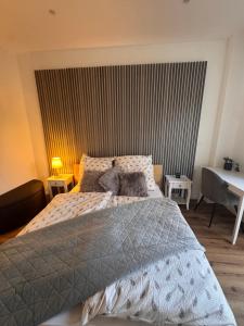 a bedroom with a bed with a gray comforter at Holiday by Chelly in Zeitz