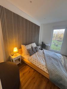 a bedroom with a large bed and a window at Holiday by Chelly in Zeitz