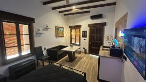 a living room with a couch and a tv in it at La Posada del Diezmo in Manzanilla