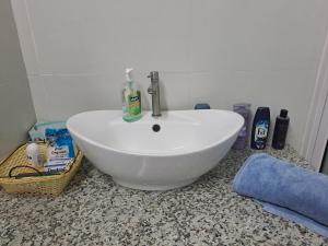 a white sink sitting on a counter in a bathroom at Authentic South in Mahébourg