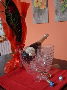 a bottle of wine in a basket next to a wine glass at Il Doganiere in Montecchio