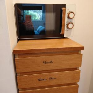 a television sitting on top of three dresser drawers at The bolt in Newhaven