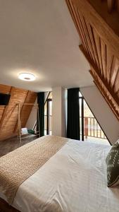 a bedroom with a large bed in a room at Dream Cottage in Paltin