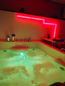 a hot tub with a red light in a room at Tudesia royal suite in Todi