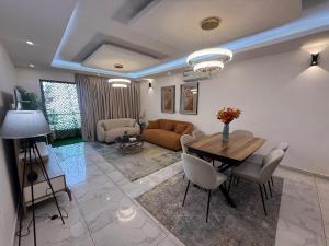 a living room with a table and a couch at Eucalyptus in Abidjan +17 photos