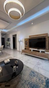 a large living room with a large flat screen tv at Eucalyptus in Abidjan