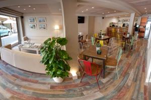 a restaurant with tables and chairs in a room at Hostal Loimar in Torre del Mar