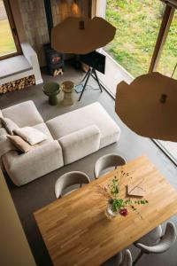 a living room with a table and a couch at Gastenverblijf Buitenhoudt in Vinkel +19 photos