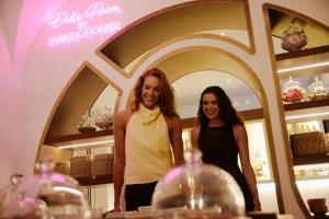two women standing in front of a mirror in a store at W Sardinia - Poltu Quatu in Porto Cervo +129 photos