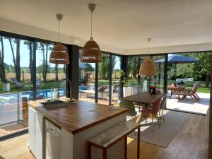 a kitchen with a table and chairs and a large window at CountrySide Heaven in Neuilly-sur-Eure