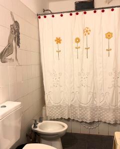 a bathroom with a toilet and a shower curtain at Moon of Salta in Salta +4 photos