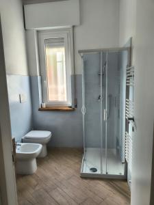 a bathroom with a shower and a toilet and a window at L'Eden in Casarza Ligure +25 photos