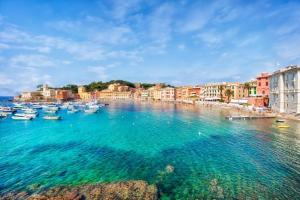 a group of boats in a body of water with buildings at L'Eden in Casarza Ligure